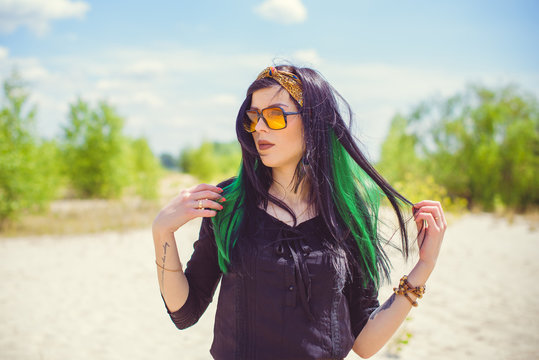 Beautiful woman with green hair posing in Indie or new Hippie style clothes . Outdoor fashion. Cute beautiful girl in boho style   