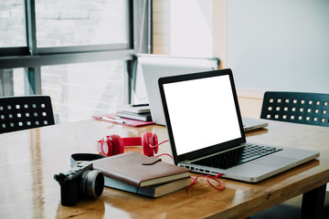 Office workplace with blank screen notebook laptop