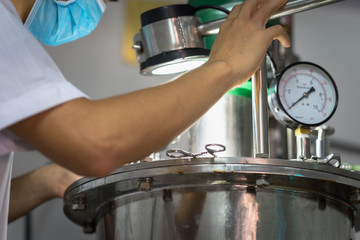 Closeup Asian worker working with ferment machine