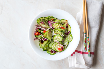Asian Cucumber Salad with Sesame and served with Chopsticks.