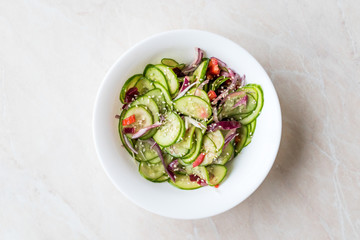 Asian Cucumber Salad with Sesame and served with Chopsticks.