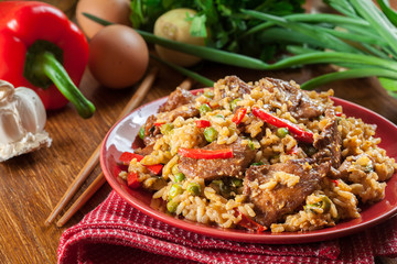 Fried rice with chicken and vegetables served on a plate