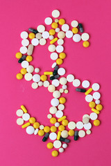 Medicine forming a sign of dollar as a concept of high cost of healthcare