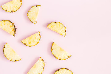 Pineapples on pastel pink background. Summer concept. Flat lay, top view, copy space