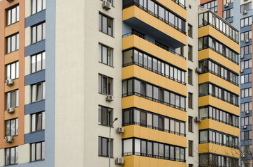 facade of a multi-storey building with yellow balconies