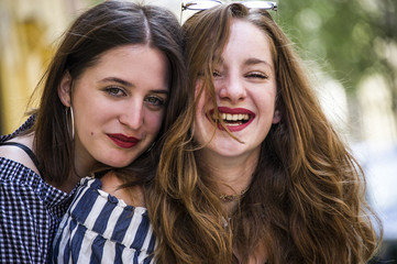 Obraz premium Two lovely girls having fun on the street. Bff conception. 