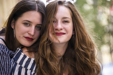 Fototapeta premium Two lovely girls having fun on the street. Bff conception. 