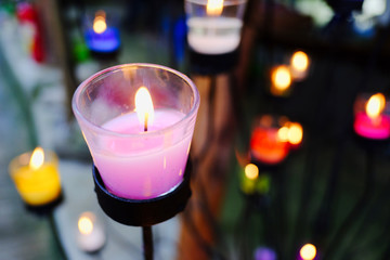 Beautiful pink candle in clear glass.