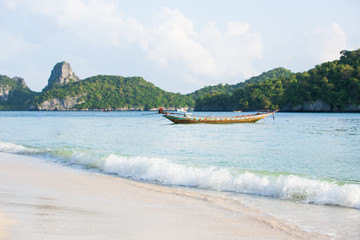 Fototapeta na wymiar Tranquil tropical beach and wooden boat.