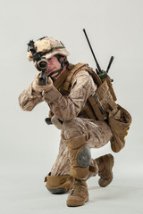 Soldier in camouflage holding rifle