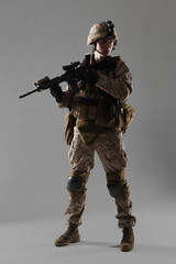 Soldier in camouflage holding rifle