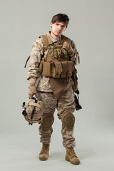 Soldier in camouflage holding rifle