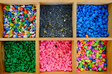 sand and gravel various colorful stones in wooden bucket box