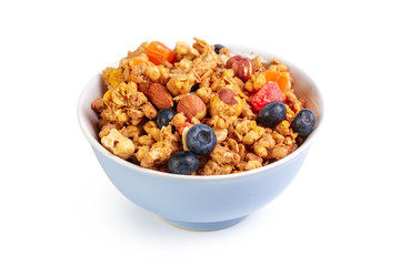 Bowl of homemade granola with fruit pieces isolated on white