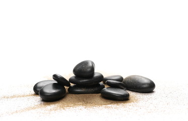 Black stones in sand pile isolated on white background