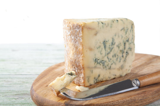 Wedge of Stilton Cheese on a Cheeseboard