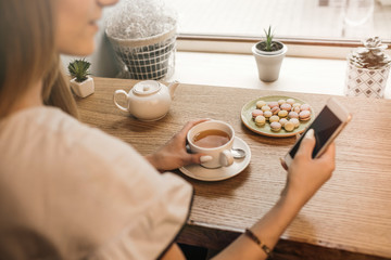 Young gorgeous lady chatting on her smart phone while relaxing i