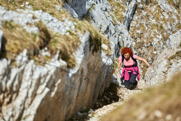 Woman climbing into the mountains