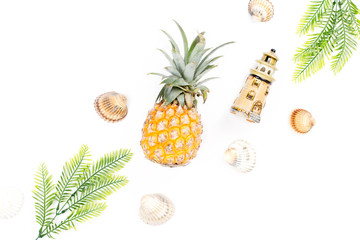 Tropical summer concept with woman fashion accessories, leaves and pineapple on white background. Flat lay, top view