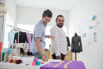 male fashion designer take a measure for clothing