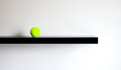 Single Tennis Ball on a shelf