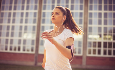 Close up image of young woman running.