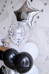 Decorations foe holiday party. Birthday party black and white colors. A lot of balloons black and white colors. One year birthday decorations. 