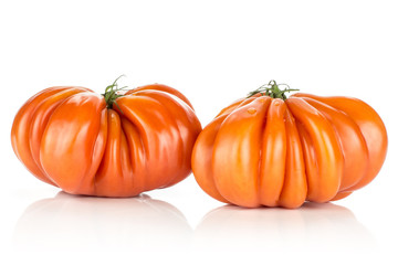 Two beef tomatoes isolated on white background big ripe red ribbing.