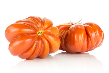 Two beef tomatoes (flower shape) isolated on white background big ripe red ribbing.
