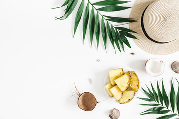 Summer composition. Tropical palm leaves, hat, pineapple, coconut on white background. Summer...