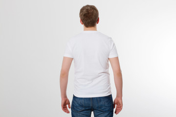 Fototapeta premium Young man wearing blank t-shirt isolated on white background. Copy space. Place for advertisement. Back view. Mock up. Template summer shirt