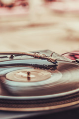 Vinyl record and turntable needle close-up. Shallow depth of field. Cinematic look, vertical orientation