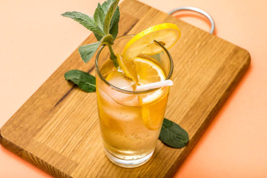 Cold refreshing summer lemonade with ice and lemon slices, decorated with mint leaves in a tall glass