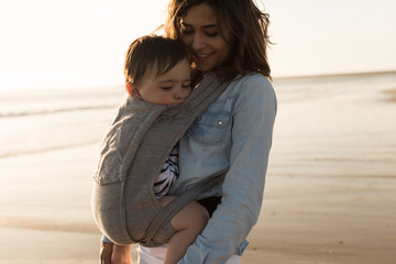 Mother carrying baby