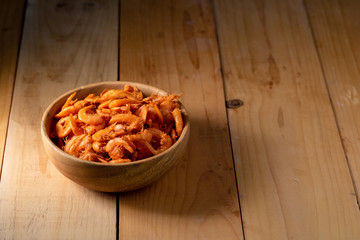 Close up dried shrimp in a wooden bowl on wooden background