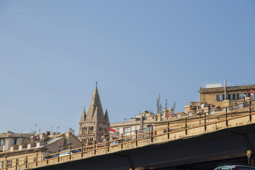 Fototapeta premium Low angle view to the bridge railings in Mediterranean European cityscape, against clear blue sky with copy space