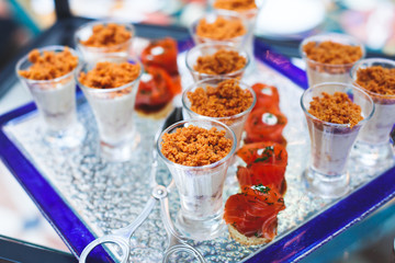 Beautifully decorated catering banquet table with variety of different food snacks and appetizers on corporate christmas birthday party event or wedding celebration