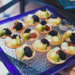 Beautifully decorated catering banquet table with variety of different food snacks and appetizers on corporate christmas birthday party event or wedding celebration