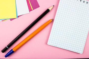 Pen and pencil. Notepad and color papers. Empty space for text and design. Office tools concept