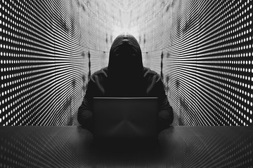 Anonymous hacker in front of his computer