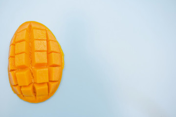 fresh ripe mango and copy space for text on blue background