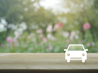 Taxi car flat icon on wooden table over blur pink flower and tree, Business service car concept