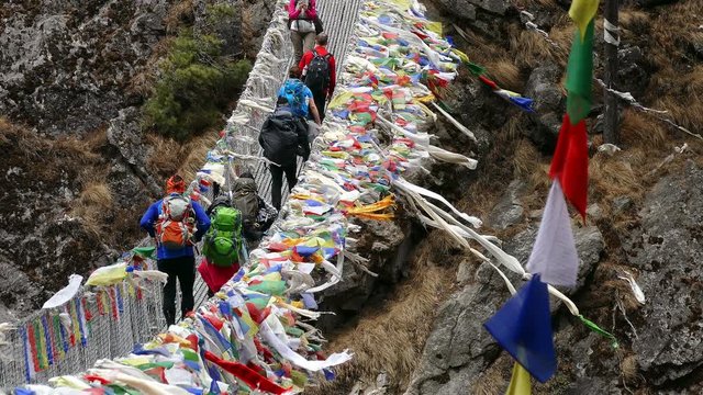 Largest suspension bridge in Solu Khumbu valley with colorful prayer flags, trekking area to the base camp of Everest peak (8848 m) in Namche Bazar.