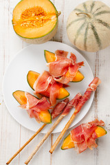 Melon with prosciutto and grissini