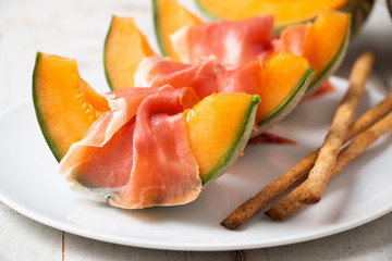 Melon with prosciutto and grissini