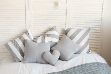 bed with grey pillows. grey bed linen