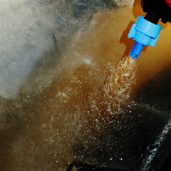 The nozzle of the watering machine sprays water.