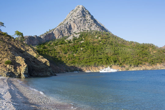 Beach in Adrasan bay, high rocky hill at back, Lycia, Province of Antalya, Turkey, resort beach