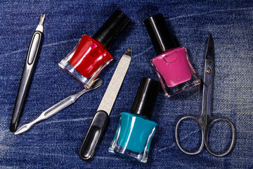 Basic set of manicure tools on jeans background