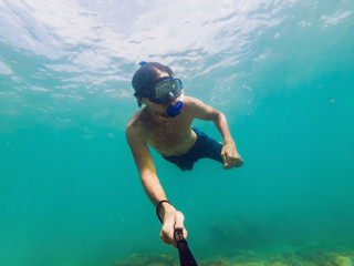 A young caucasian snorkeling man under water selfie Thailand